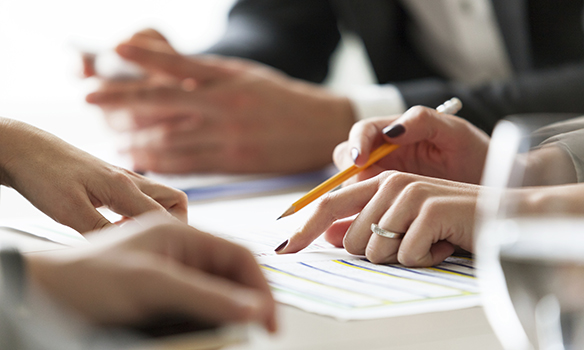 Close up of businesswoman at meeting, pointing at gantt chart