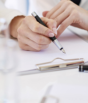 Hands of business people taking notes in meeting