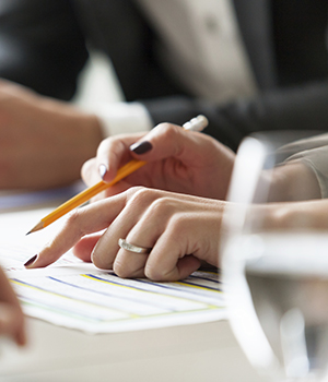 Close up of businesswoman at meeting, pointing at gantt chart